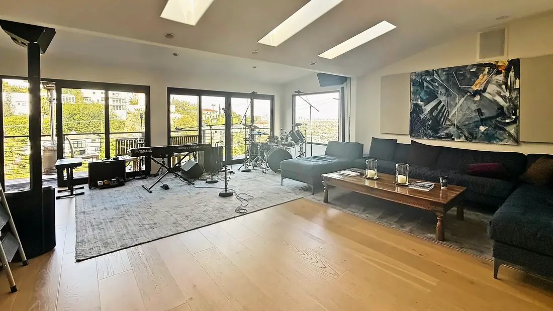 Great room under skylights with keys, drums and a long sectional