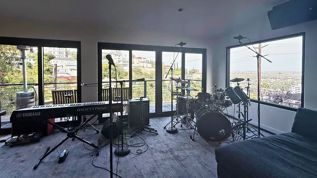 Live room with drum kit and Yamaha Montage keys above the city