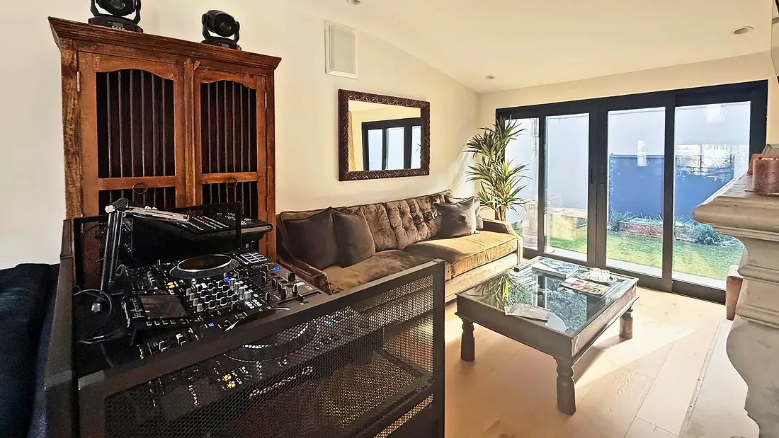 Lounge with a DJ controller and garden doors